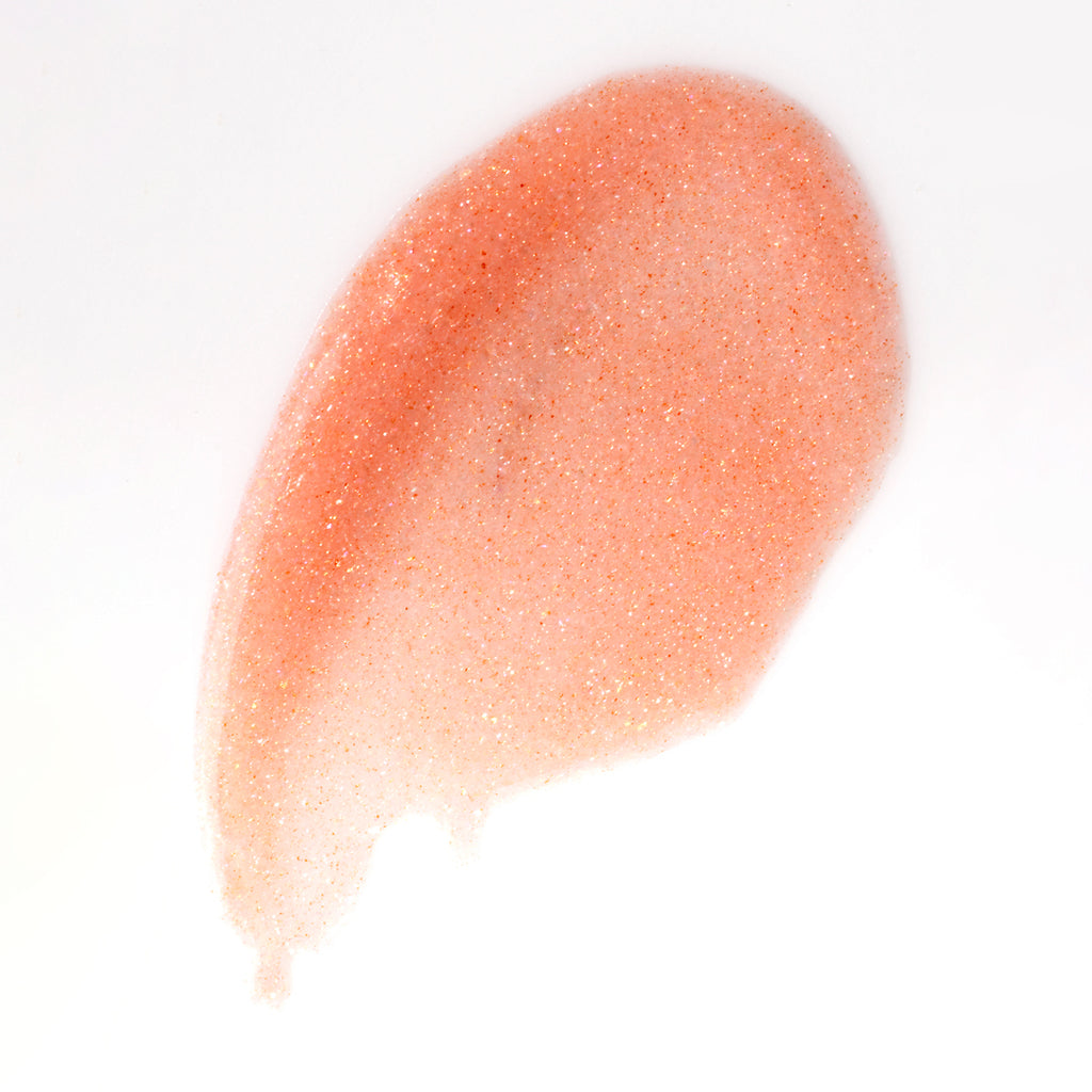 Texture of Darling lip gloss showing its delicate, glossy color for full lips.